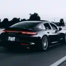 running black Porsche sedan