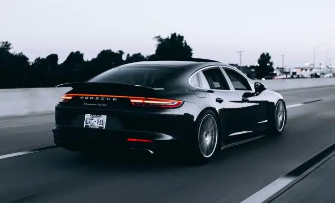 running black Porsche sedan