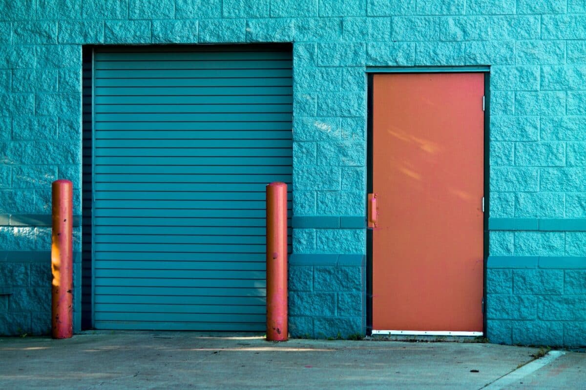 Brown Panel Door Near Roll-up Gate