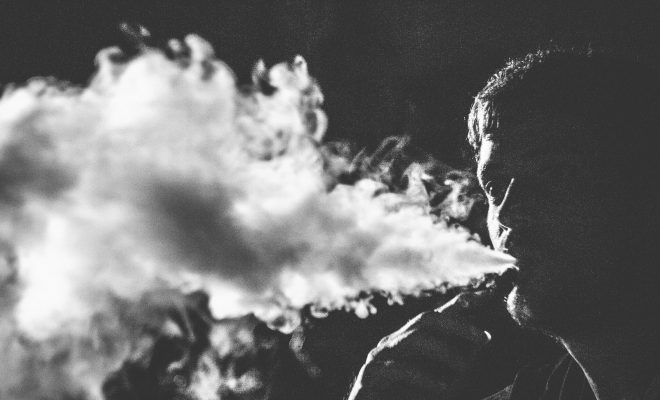 grayscale photography of smoking man